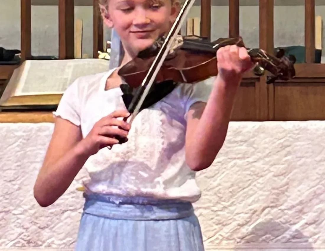 A young KSA string student performing at a recital