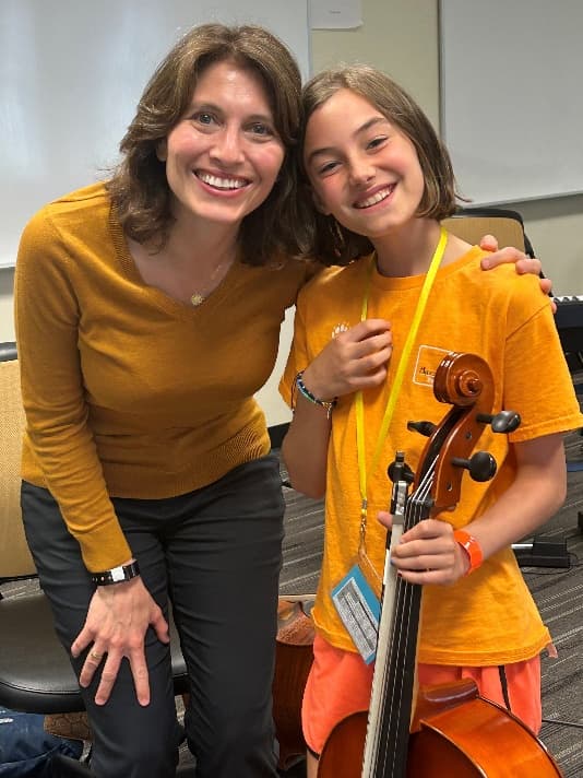 Cello student with a teacher at a summer music program