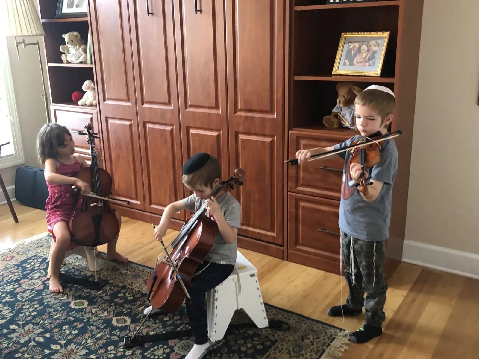 Children making string music together