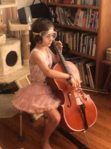 Image showing the use of scuba goggles to prevent the child from looking at the fingerboard.