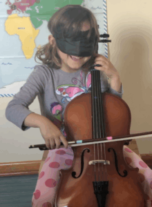 Image showing the use of a blindfold to prevent the child from looking at the fingerboard.